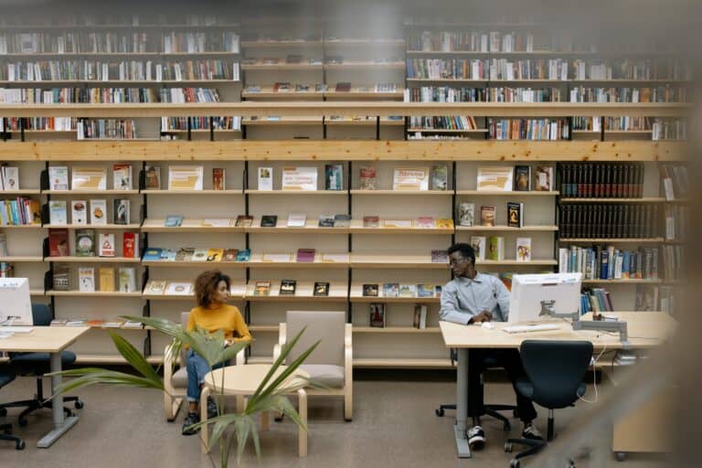 College students in the library in the concept of 'top schools in Enfield'.